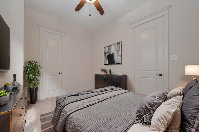carpeted bedroom with a ceiling fan and baseboards
