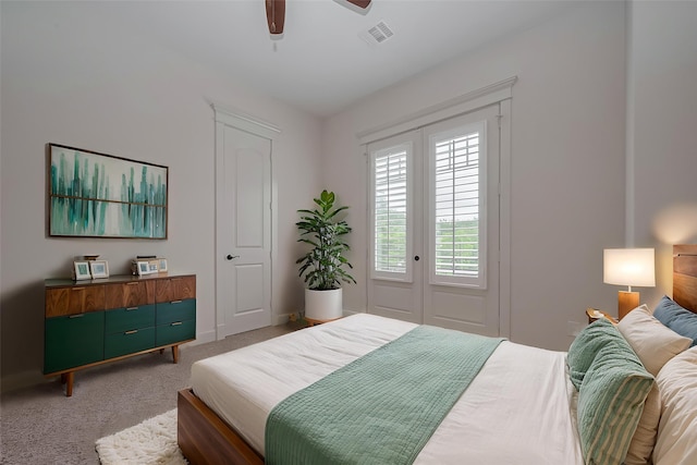 bedroom featuring a ceiling fan, baseboards, visible vents, and light carpet