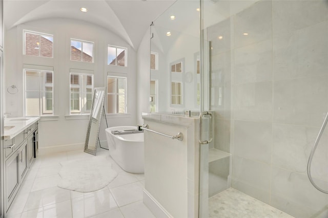 full bathroom featuring tile patterned flooring, a freestanding bath, a stall shower, and a wealth of natural light