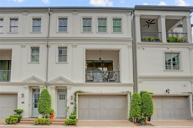 townhome / multi-family property with an attached garage, driveway, and a balcony