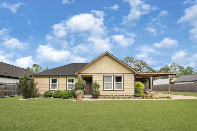 ranch-style house featuring board and batten siding, fence, a front yard, and an attached carport