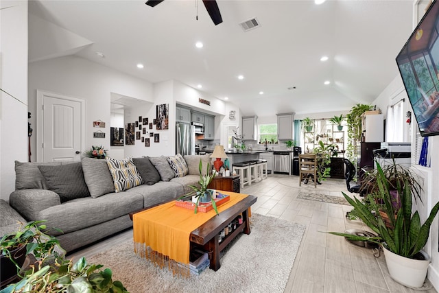 living area with visible vents, a ceiling fan, vaulted ceiling, and recessed lighting