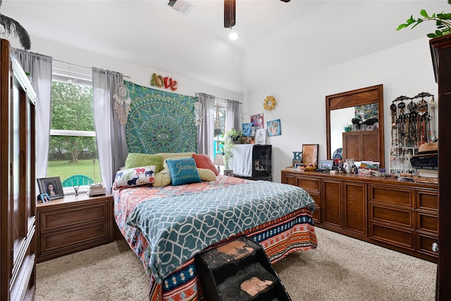 bedroom featuring visible vents, carpet flooring, multiple windows, and lofted ceiling