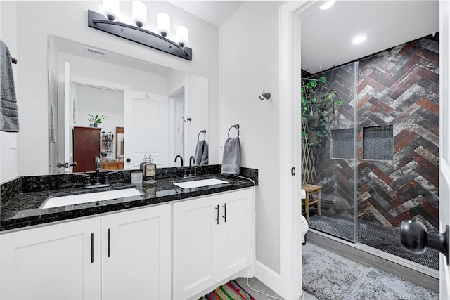 bathroom with visible vents, a sink, and a stall shower