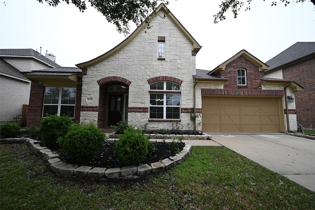view of front of property featuring driveway, stone siding, and a garage