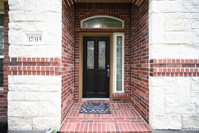 property entrance with brick siding