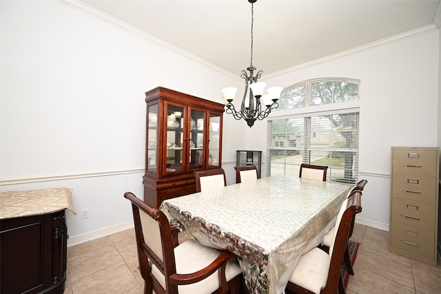 dining space with an inviting chandelier, baseboards, crown molding, and light tile patterned floors