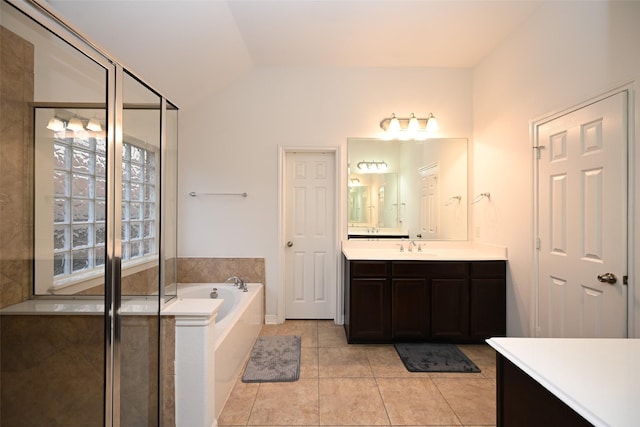 full bath with vanity, a garden tub, tile patterned flooring, lofted ceiling, and a stall shower