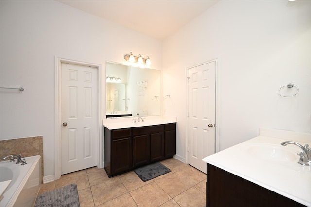 bathroom featuring tile patterned floors, a sink, a bath, and two vanities