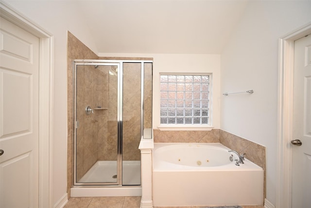 full bathroom with vaulted ceiling, a shower stall, tile patterned flooring, and a jetted tub