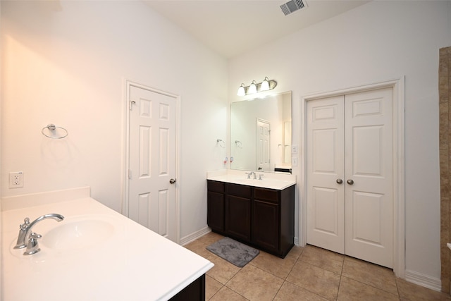 bathroom featuring vanity, baseboards, tile patterned floors, and visible vents