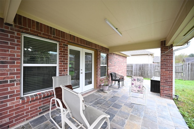 view of patio / terrace featuring fence and french doors