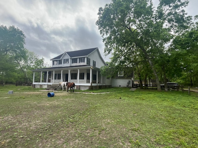 back of house featuring covered porch, crawl space, and a lawn