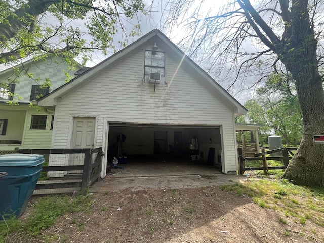 view of side of property with a garage and fence