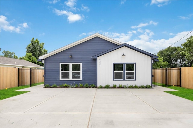 back of property with fence and a patio