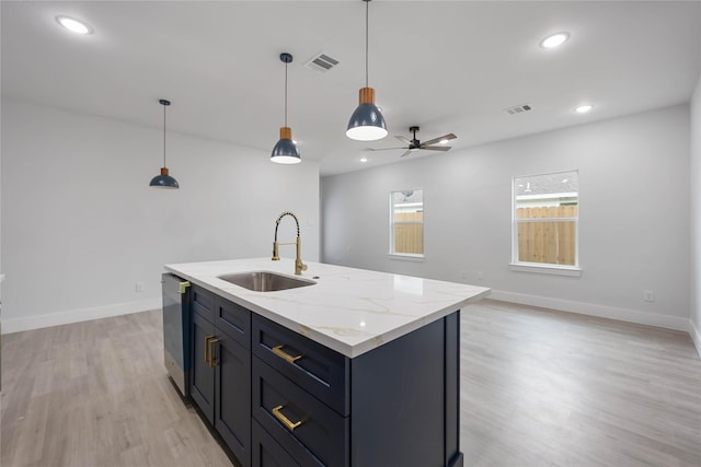 kitchen featuring visible vents, a sink, light wood finished floors, and dishwasher