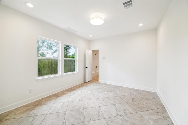 empty room featuring visible vents, recessed lighting, and baseboards