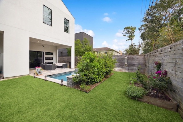 view of yard with a fenced backyard, a ceiling fan, a patio, and an outdoor living space