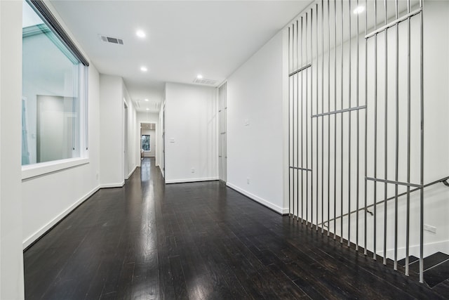 corridor featuring recessed lighting, baseboards, visible vents, and hardwood / wood-style floors
