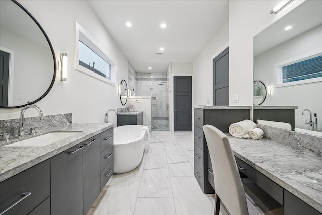 full bath featuring marble finish floor, recessed lighting, a freestanding bath, a shower stall, and a sink