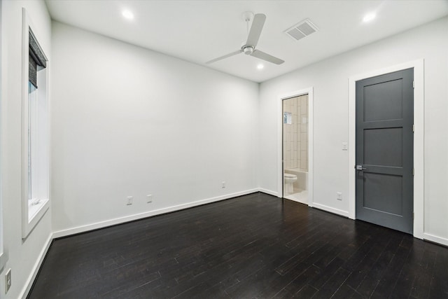 unfurnished bedroom with visible vents, dark wood-style flooring, ensuite bathroom, baseboards, and recessed lighting