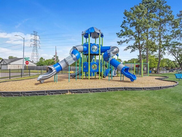 communal playground with a yard and fence