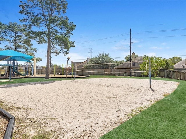 surrounding community featuring fence, playground community, and volleyball court