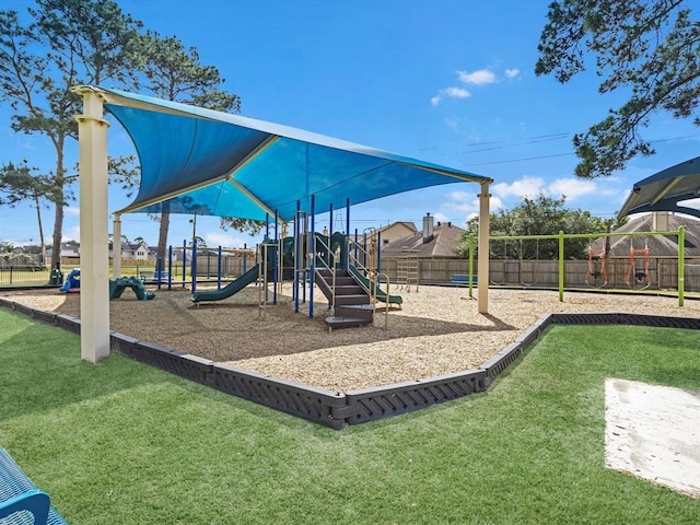 communal playground with fence and a yard