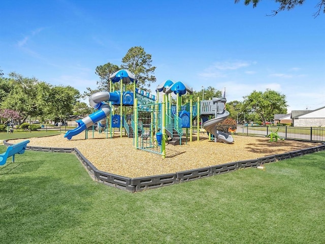 community playground featuring fence and a lawn