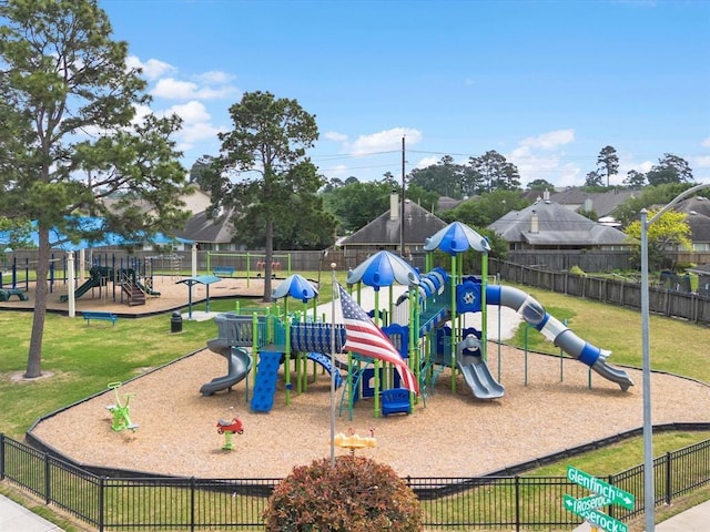 community jungle gym with fence and a yard