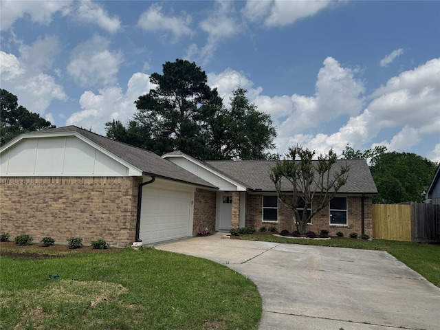 ranch-style home featuring brick siding, an attached garage, fence, and a front yard