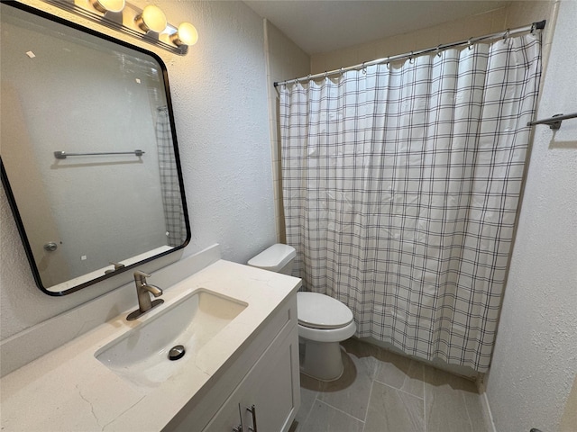 bathroom featuring vanity, a textured wall, toilet, and a shower with curtain
