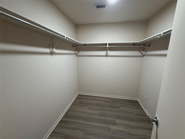 walk in closet featuring visible vents and dark wood-style flooring