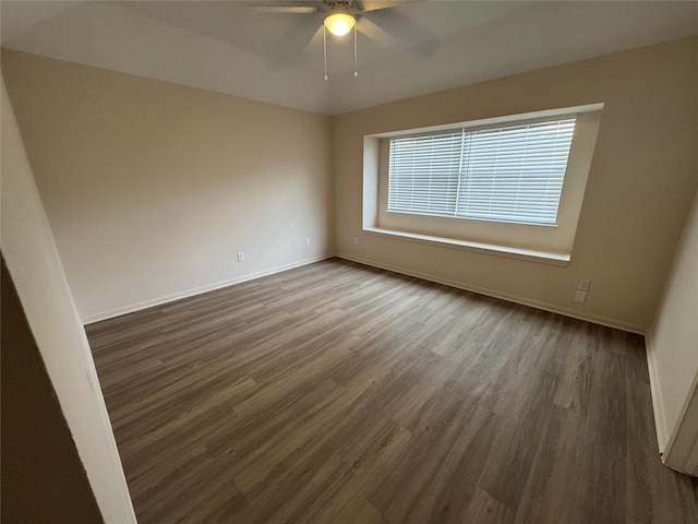 empty room with baseboards, a ceiling fan, and wood finished floors