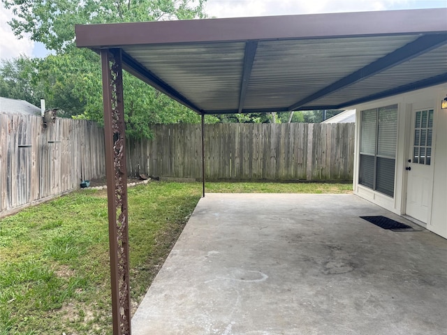 view of patio / terrace featuring a fenced backyard and an attached carport