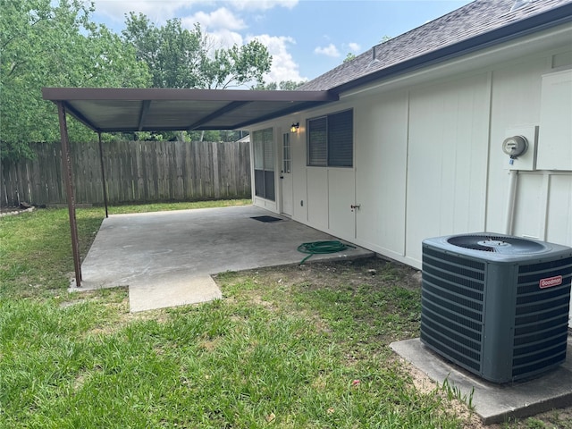 exterior space featuring central AC unit and fence