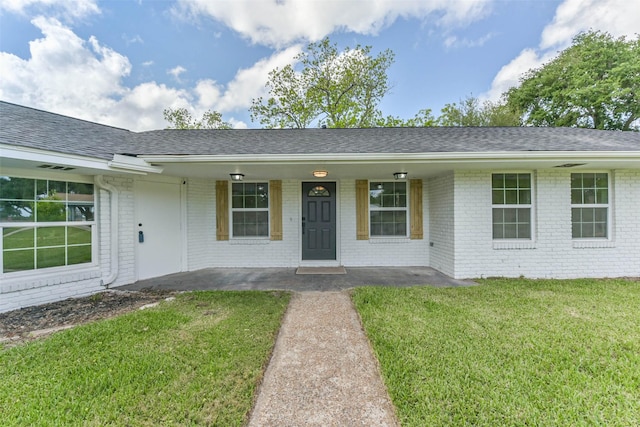 22 13th Ave N, Texas City, TX 77590 - single story home featuring brick siding, roof with shingles, a front yard, and a porch