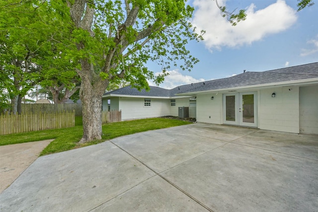 22 13th Ave N, Texas City, TX 77590 - rear view of house with fence, a patio, roof with shingles, french doors, and a lawn