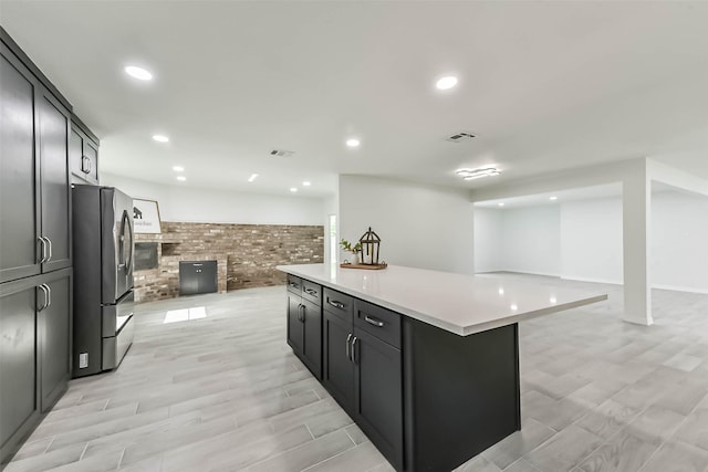 22 13th Ave N, Texas City, TX 77590 - kitchen featuring visible vents, light wood-style floors, open floor plan, stainless steel refrigerator with ice dispenser, and light countertops