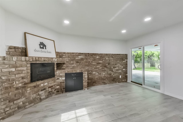 22 13th Ave N, Texas City, TX 77590 - unfurnished living room with a fireplace, recessed lighting, and brick wall