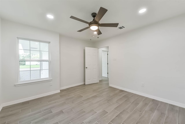 22 13th Ave N, Texas City, TX 77590 - spare room with baseboards, ceiling fan, light wood finished floors, and visible vents