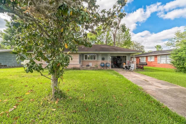 116 Chestnut St, Lake Jackson, TX 77566 - back of house featuring an attached garage, a yard, and concrete driveway