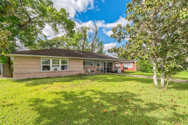 116 Chestnut St, Lake Jackson, TX 77566 - rear view of house featuring a lawn, brick siding, and cooling unit