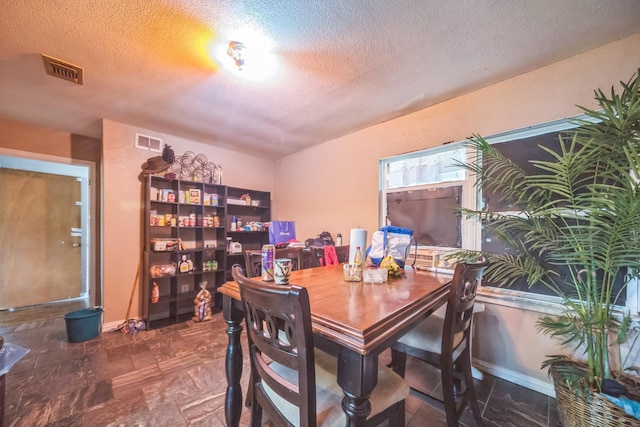 116 Chestnut St, Lake Jackson, TX 77566 - dining room featuring visible vents, a textured ceiling, and baseboards