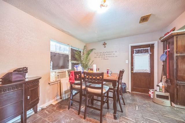 116 Chestnut St, Lake Jackson, TX 77566 - dining area featuring a textured ceiling, visible vents, baseboards, and cooling unit