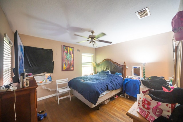 116 Chestnut St, Lake Jackson, TX 77566 - bedroom with a ceiling fan, baseboards, visible vents, and wood finished floors
