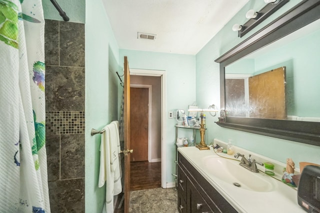 116 Chestnut St, Lake Jackson, TX 77566 - full bathroom with visible vents, a tile shower, and vanity