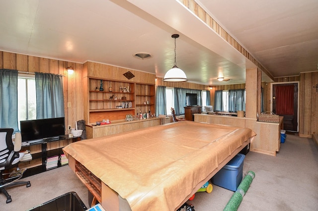 rec room with carpet flooring, billiards, a healthy amount of sunlight, and wood walls