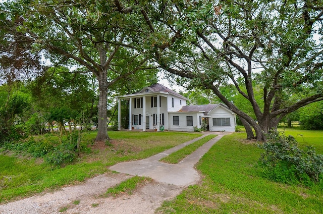 neoclassical / greek revival house with driveway and a front yard