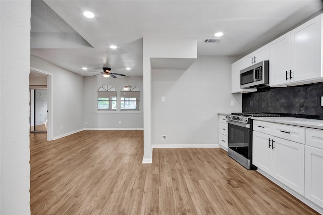18330 Cape Bahamas Ln, Houston, TX 77058 - kitchen featuring decorative backsplash, a ceiling fan, baseboards, stainless steel appliances, and recessed lighting